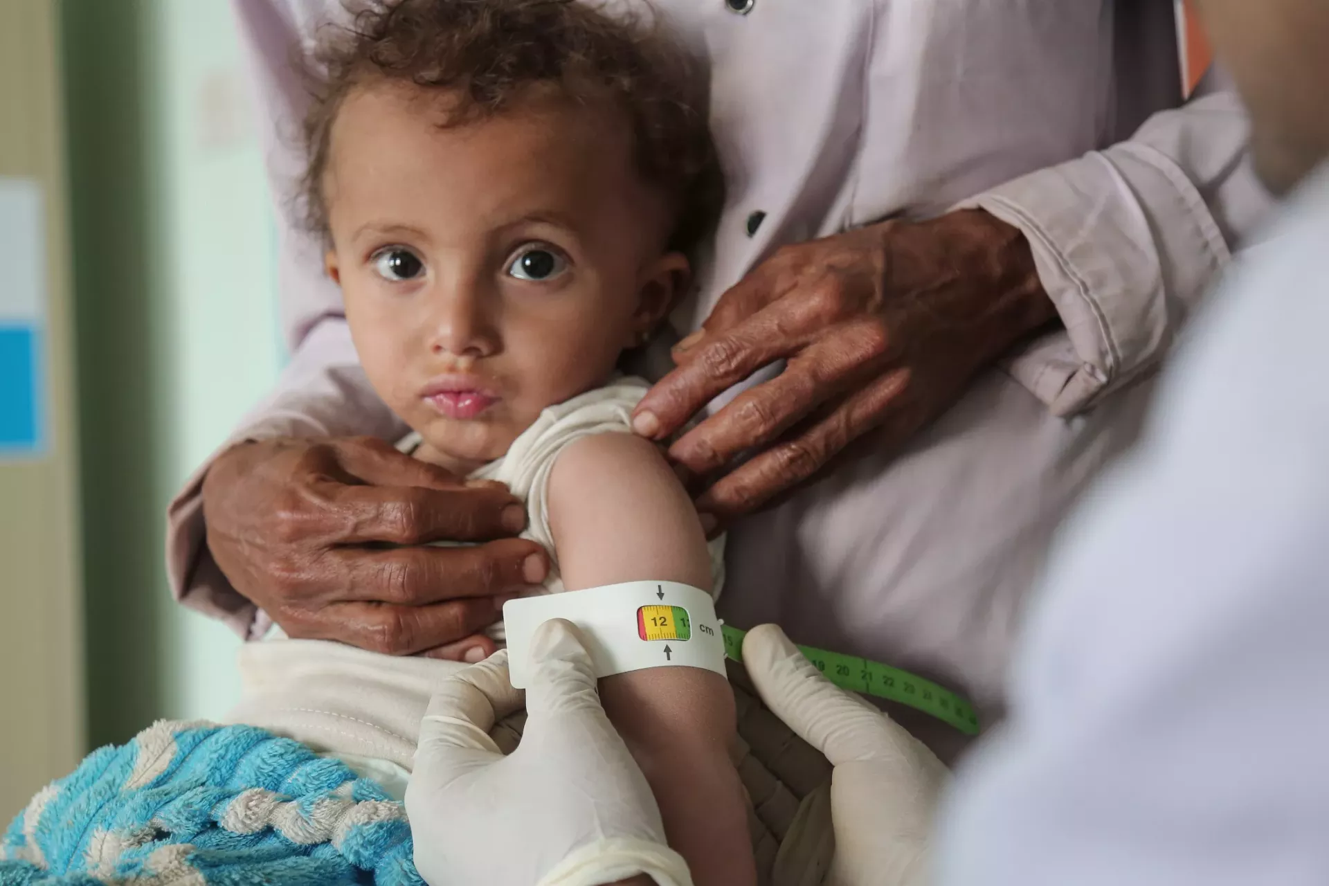 An infant being tested by medical professionals